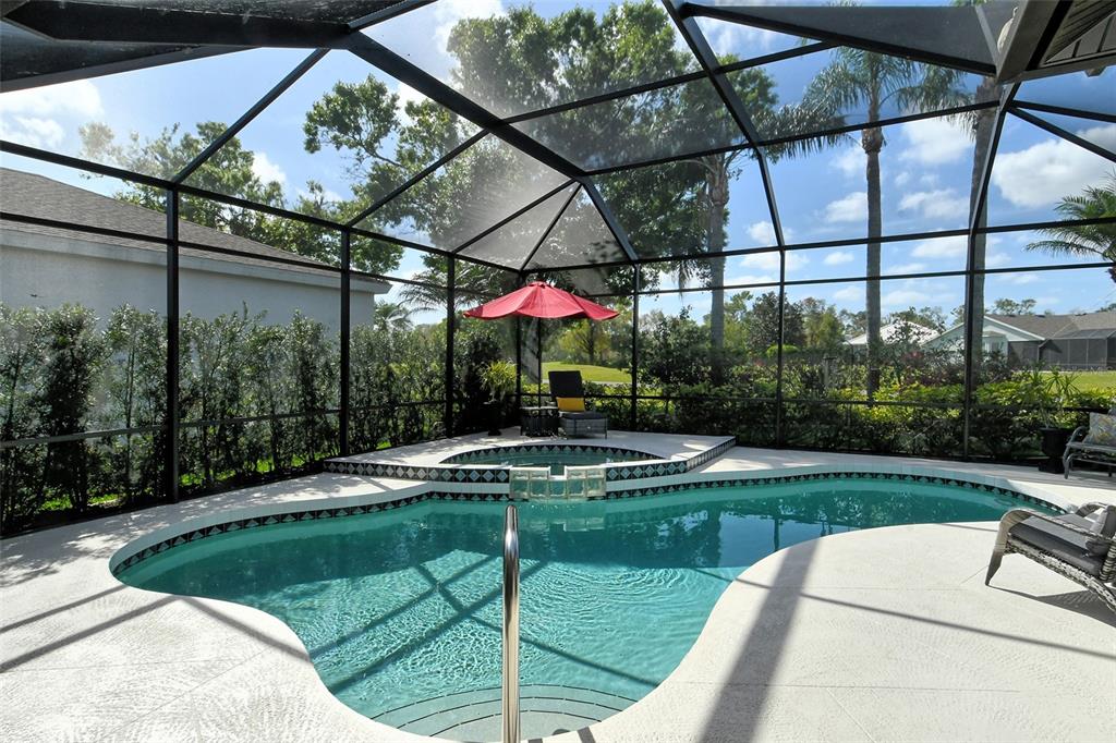 6738 Pleasant Hill Road Bradenton, FL 34203 - Photo 26 of 93 a view of a swimming pool with a patio and a garden