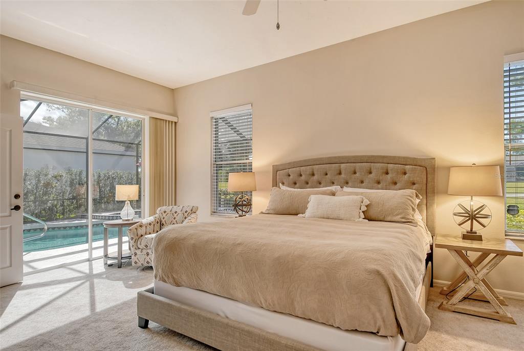 6738 Pleasant Hill Road Bradenton, FL 34203 - Photo 31 of 93 a bedroom with a large bed and a large window with outer view