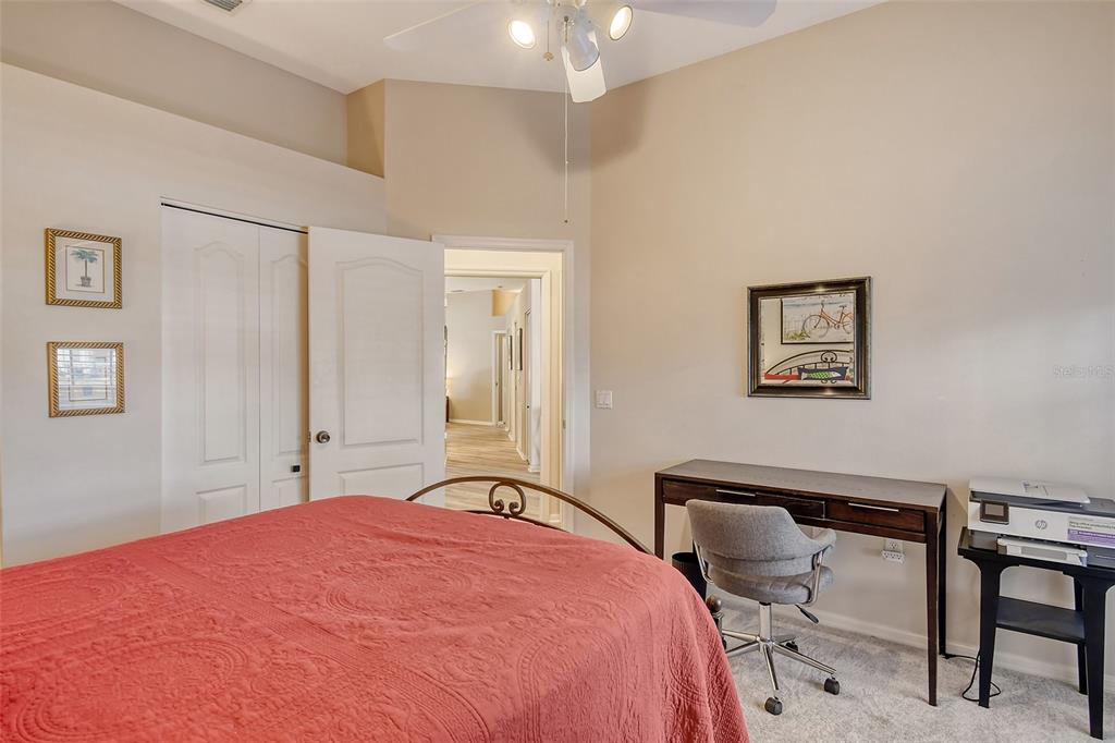 6738 Pleasant Hill Road Bradenton, FL 34203 - Photo 40 of 93 a bedroom with a bed and a chandelier