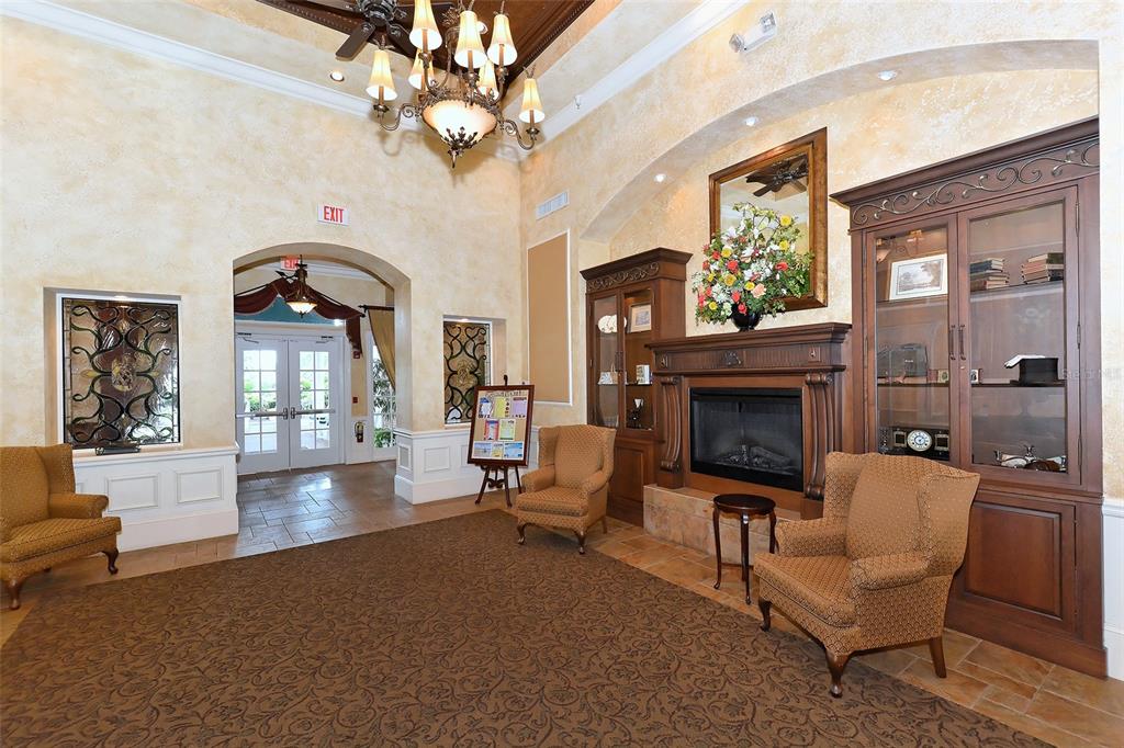 6738 Pleasant Hill Road Bradenton, FL 34203 - Photo 52 of 93 a living room with furniture a chandelier and a fireplace