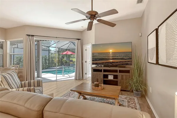 a kitchen with stainless steel appliances granite countertop a sink a stove a refrigerator and island with wooden floor