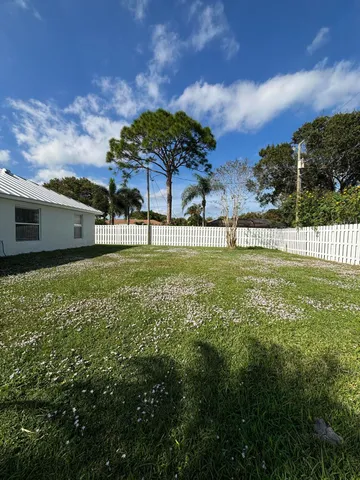 a view of a garden with a building in the background