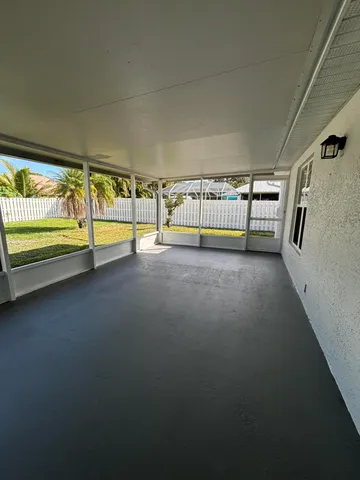a view of an empty room with glass windows