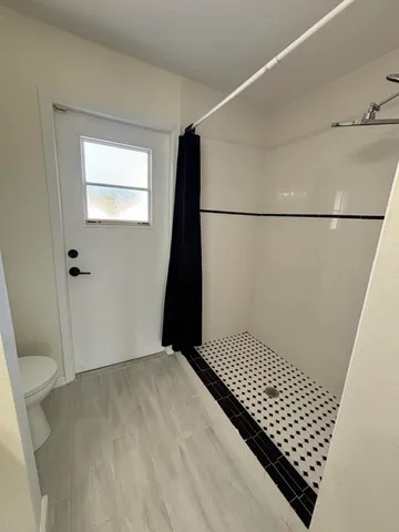 a view of a room with wooden floor and staircase