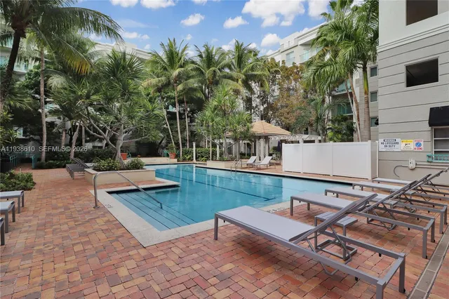 a view of a patio with table and chairs and a barbeque with potted plants