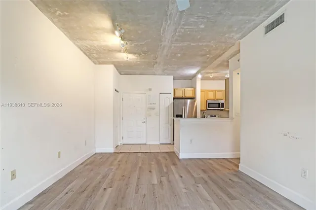a view of a hallway with wooden floor