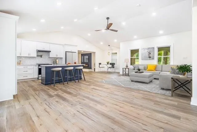 a living room with furniture and kitchen view