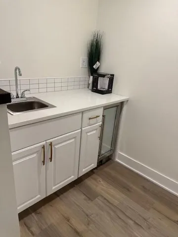 a utility room with sink dryer and washer