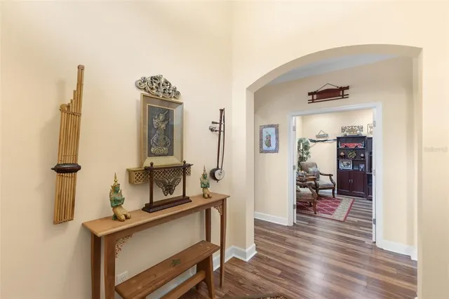 a kitchen with stainless steel appliances granite countertop a refrigerator a sink dishwasher a stove and white countertops with wooden floor