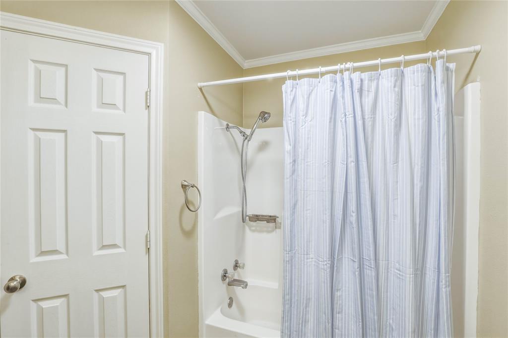 110 Peggy Ruth Drive Longview, TX 75605 - Photo 18 of 27 White fiberglass tub/shower combination with a chrome shower head and faucet