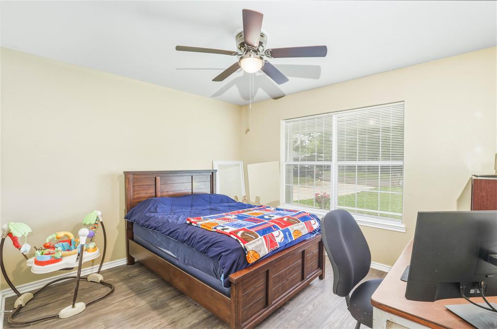 110 Peggy Ruth Drive Longview, TX 75605 - Photo 19 of 27 Bright room featuring wood-finish flooring, a ceiling fan with integrated lighting, and a large window with blinds
