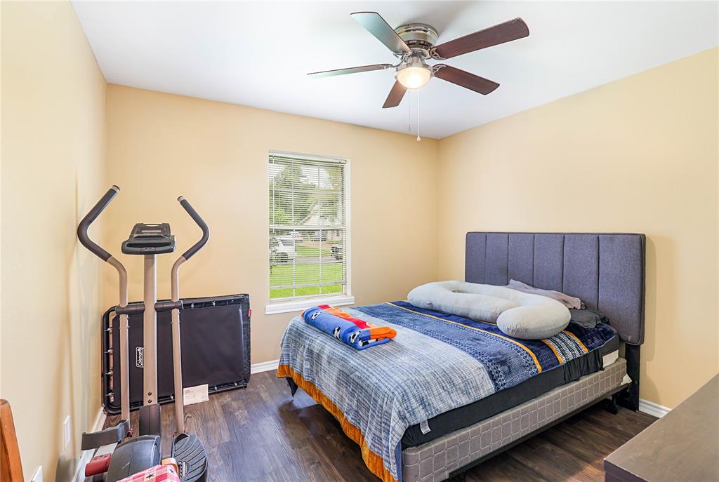 110 Peggy Ruth Drive Longview, TX 75605 - Photo 20 of 27 Room featuring wood-finish flooring, a ceiling fan with integrated lighting, and a window with blinds