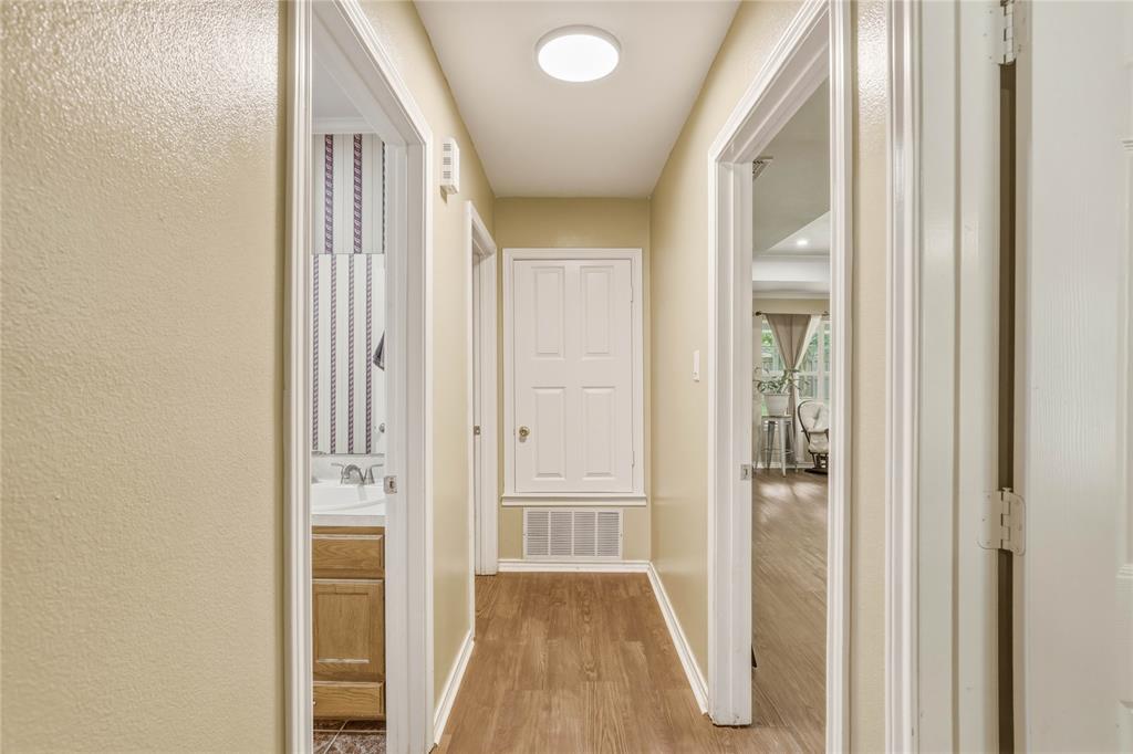 110 Peggy Ruth Drive Longview, TX 75605 - Photo 21 of 27 Central hallway with wood-finish flooring and a flush-mount ceiling light