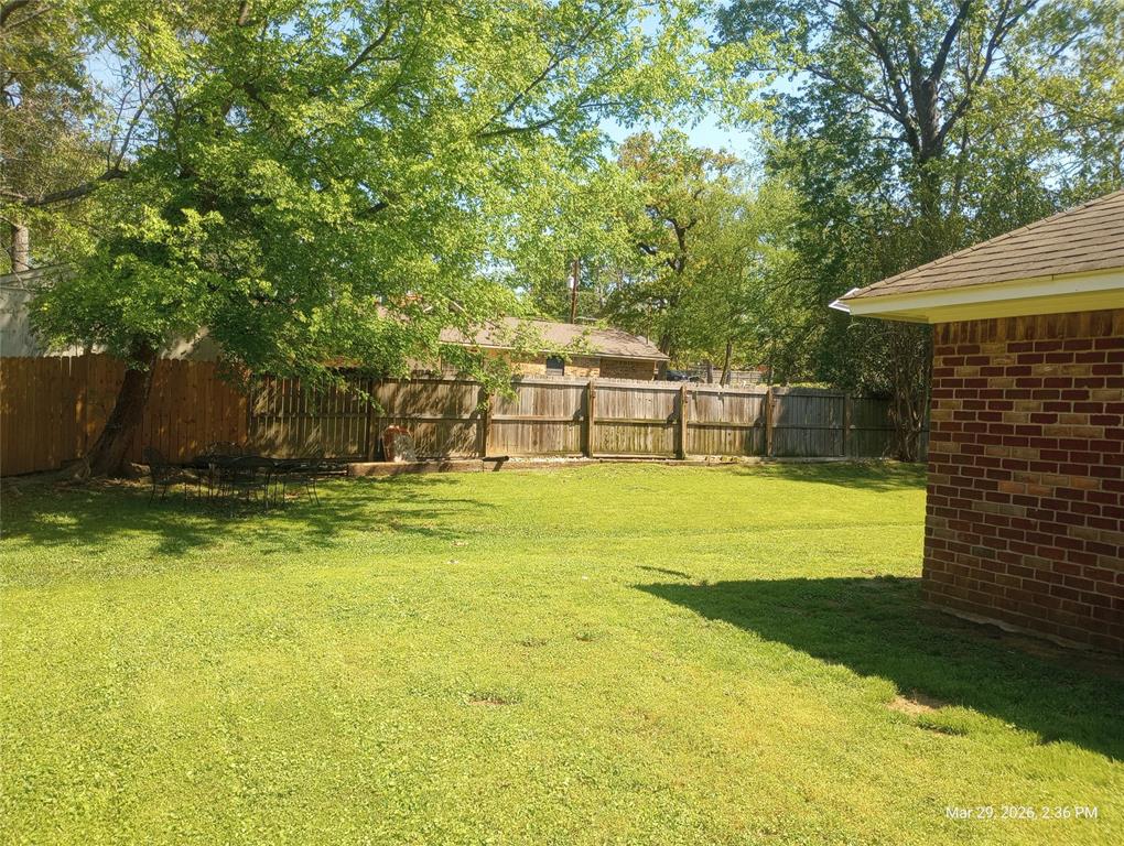 110 Peggy Ruth Drive Longview, TX 75605 - Photo 4 of 27 Expansive green lawn with a full privacy fence