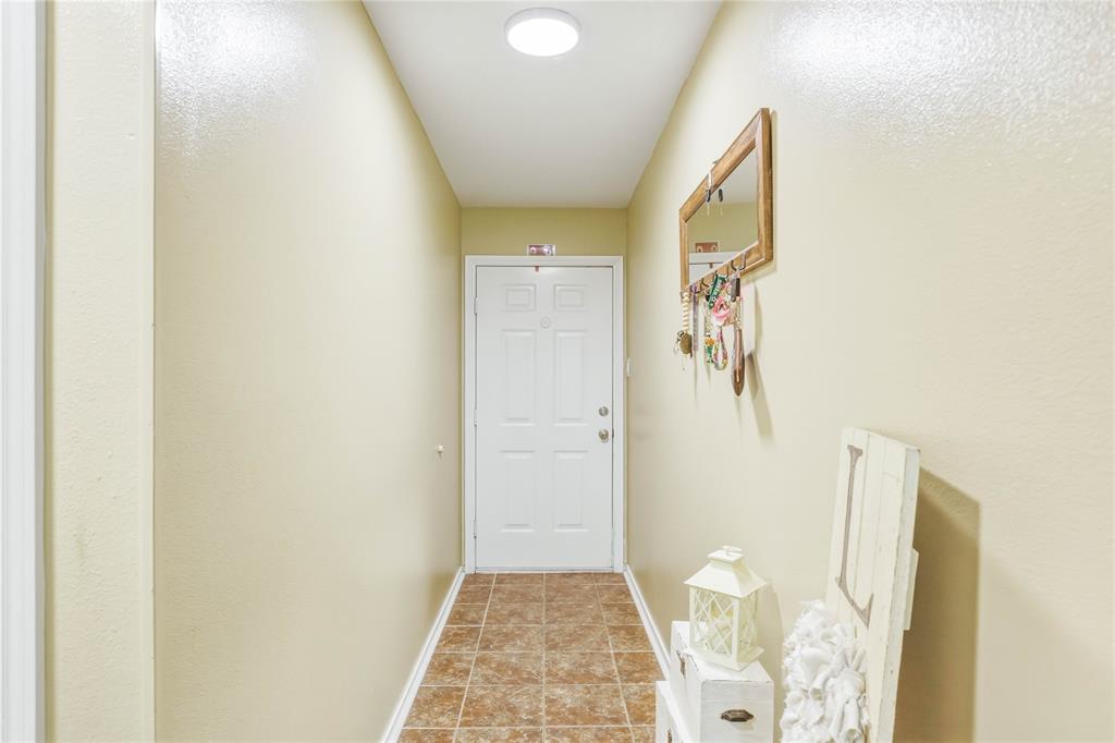 110 Peggy Ruth Drive Longview, TX 75605 - Photo 5 of 27 Entryway featuring a paneled door, flush-mount ceiling light, and tiled flooring