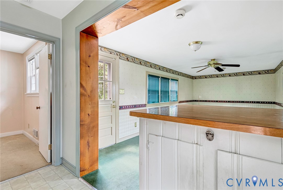 8728 Holly Hill Road Henrico, VA 23229 - Photo 13 of 36 Kitchen featuring light carpet, wallpapered walls,
