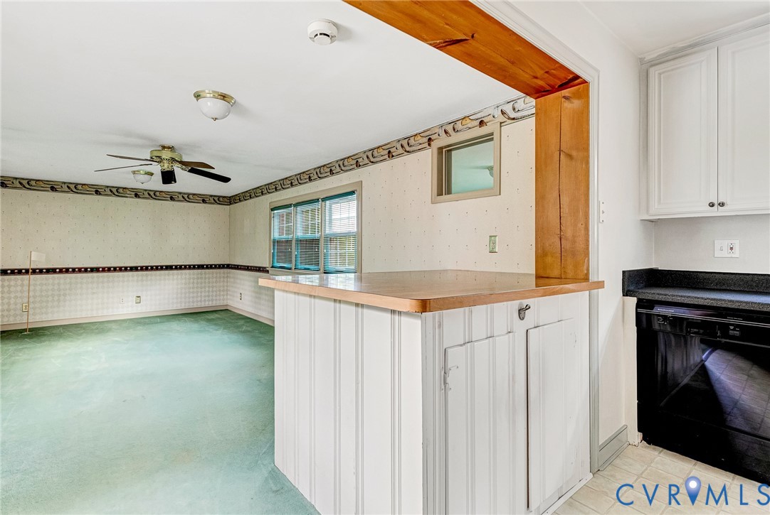 8728 Holly Hill Road Henrico, VA 23229 - Photo 14 of 36 Kitchen featuring wallpapered walls, black dishwas