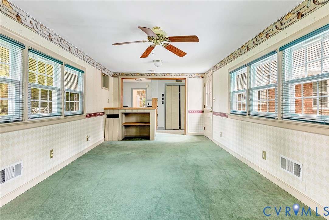 8728 Holly Hill Road Henrico, VA 23229 - Photo 18 of 36 Empty room with wallpapered walls, ceiling fan, li