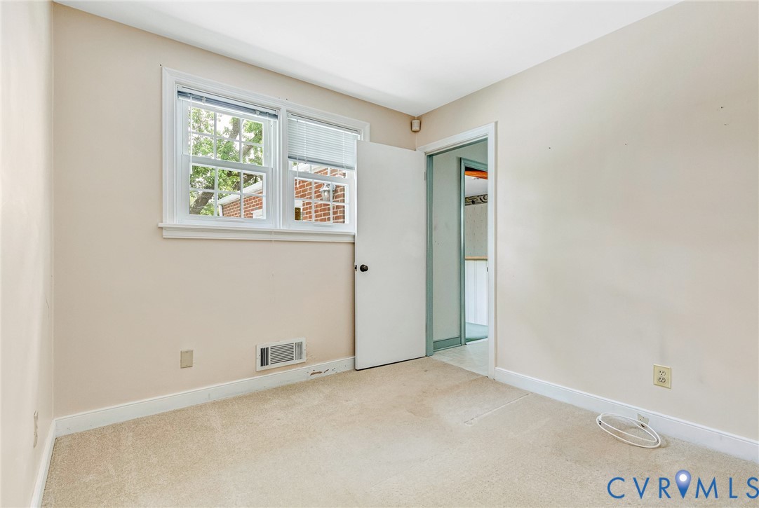 8728 Holly Hill Road Henrico, VA 23229 - Photo 25 of 36 Carpeted spare room featuring baseboards