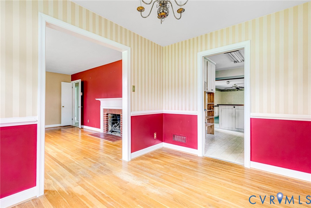 8728 Holly Hill Road Henrico, VA 23229 - Photo 9 of 36 Empty room featuring wallpapered walls, wainscotin