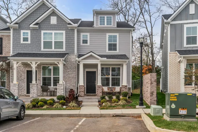 a front view of a house with a garden and plants