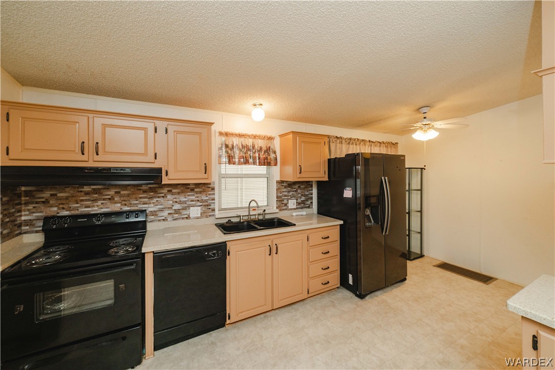 3003 Hualapai Mountain Road Kingman, AZ 86401 - Photo 14 of 49 a kitchen with stainless steel appliances granite countertop a stove a refrigerator and a sink