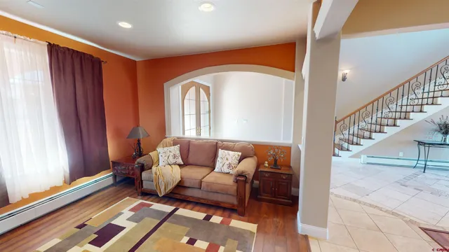 a view of a hallway with dining room and stairs