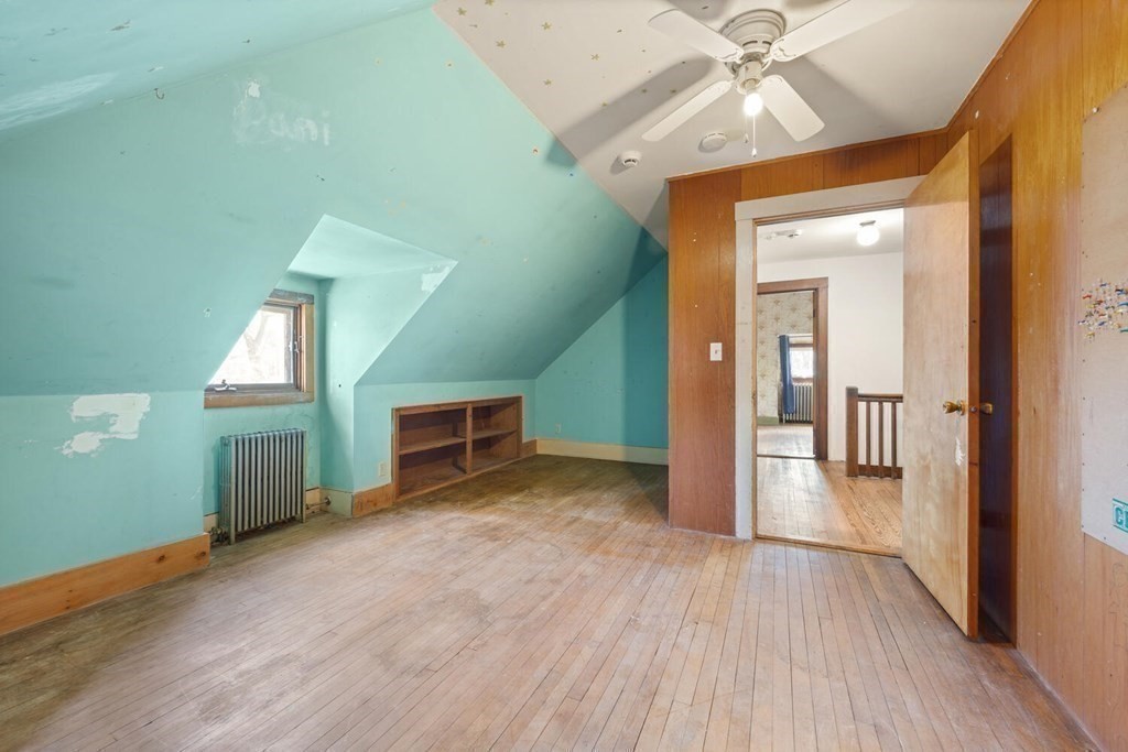 11 Stratford Road Winchester, MA 01890 - Photo 21 of 31 an empty room with a fireplace and wooden floor