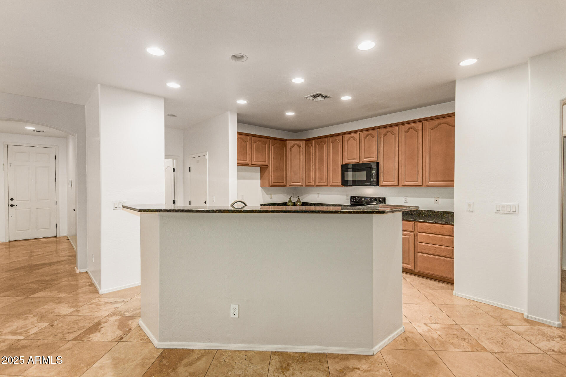 9228 West Black Hill Road Peoria, AZ 85383 - Photo 11 of 44 a kitchen with stainless steel appliances granite countertop a refrigerator sink and cabinets