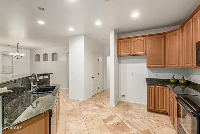 a kitchen with stainless steel appliances granite countertop a refrigerator sink and cabinets