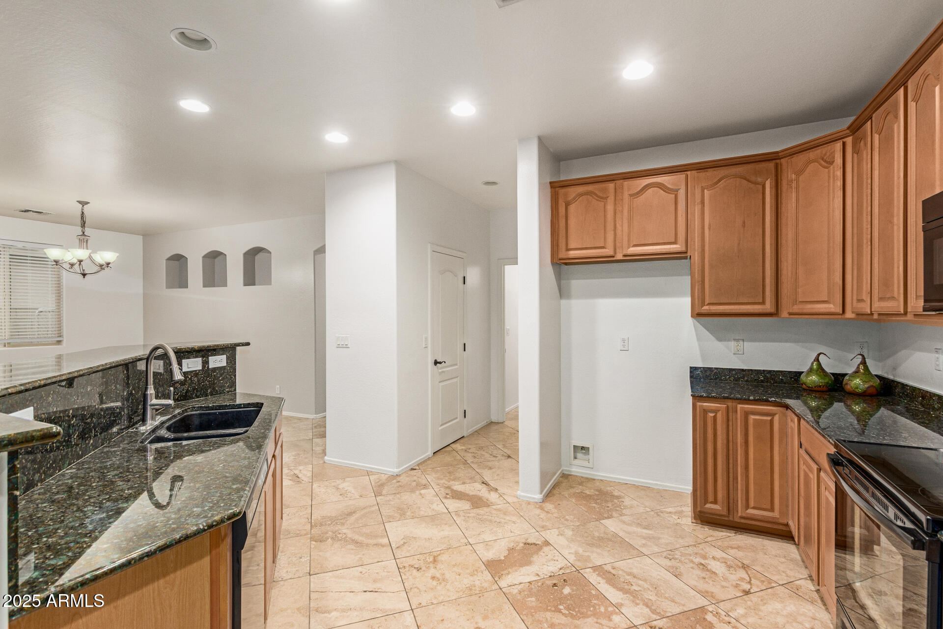 9228 West Black Hill Road Peoria, AZ 85383 - Photo 12 of 44 a kitchen with a stove a sink and a refrigerator