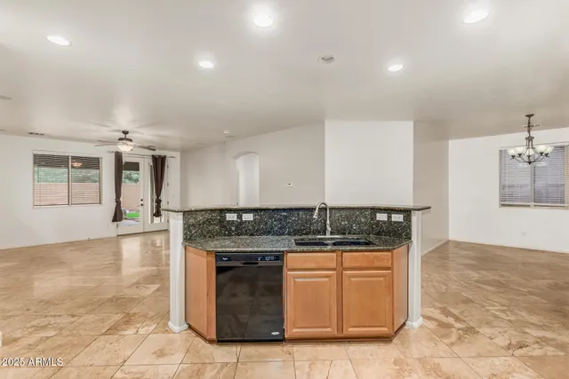 a kitchen with stainless steel appliances granite countertop a stove a sink and a refrigerator