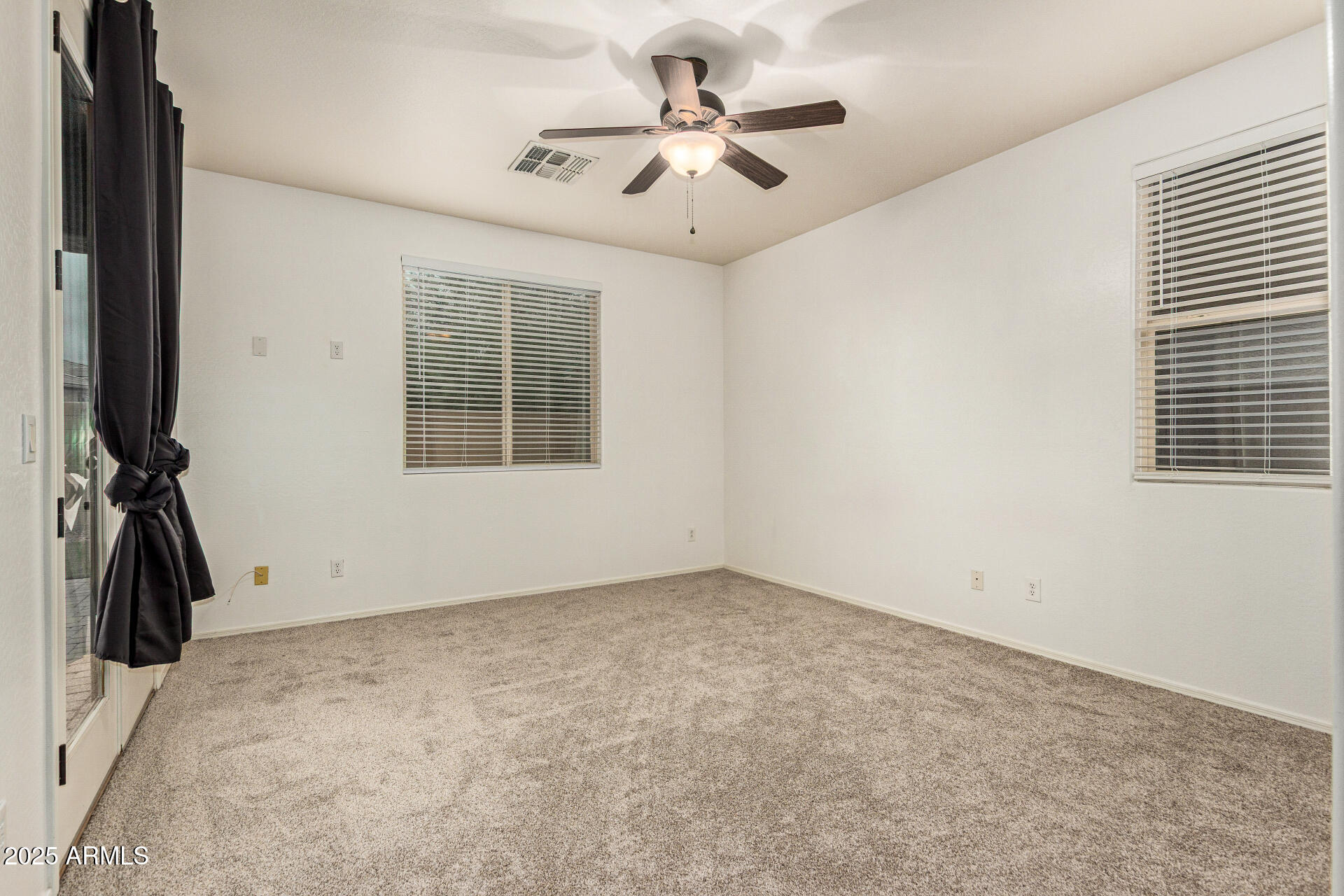 9228 West Black Hill Road Peoria, AZ 85383 - Photo 17 of 44 a view of a livingroom with a ceiling fan and window