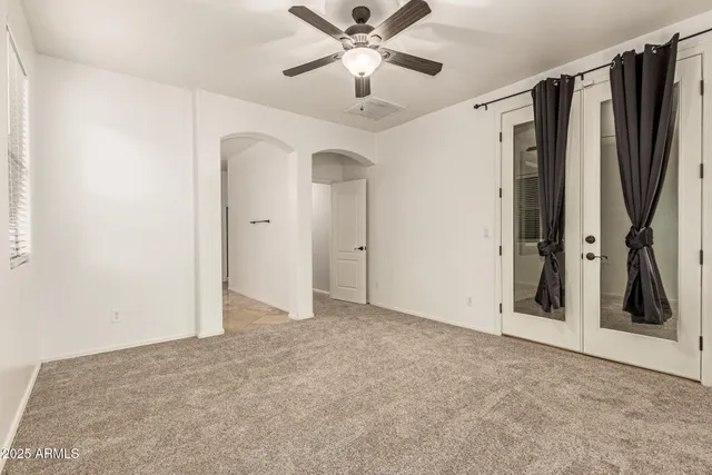 a view of a livingroom with a ceiling fan and window