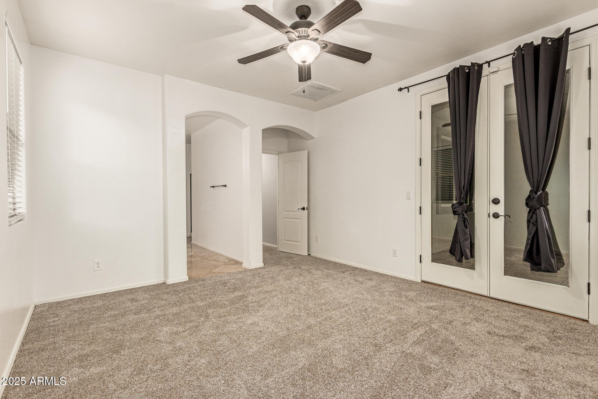 9228 West Black Hill Road Peoria, AZ 85383 - Photo 18 of 44 a view of a hallway with a ceiling fan