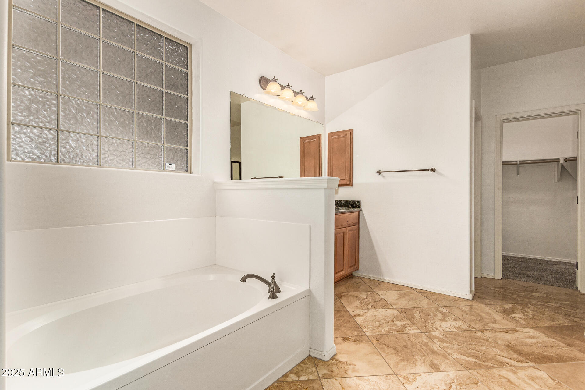9228 West Black Hill Road Peoria, AZ 85383 - Photo 20 of 44 a bathroom with a bathtub and a shower