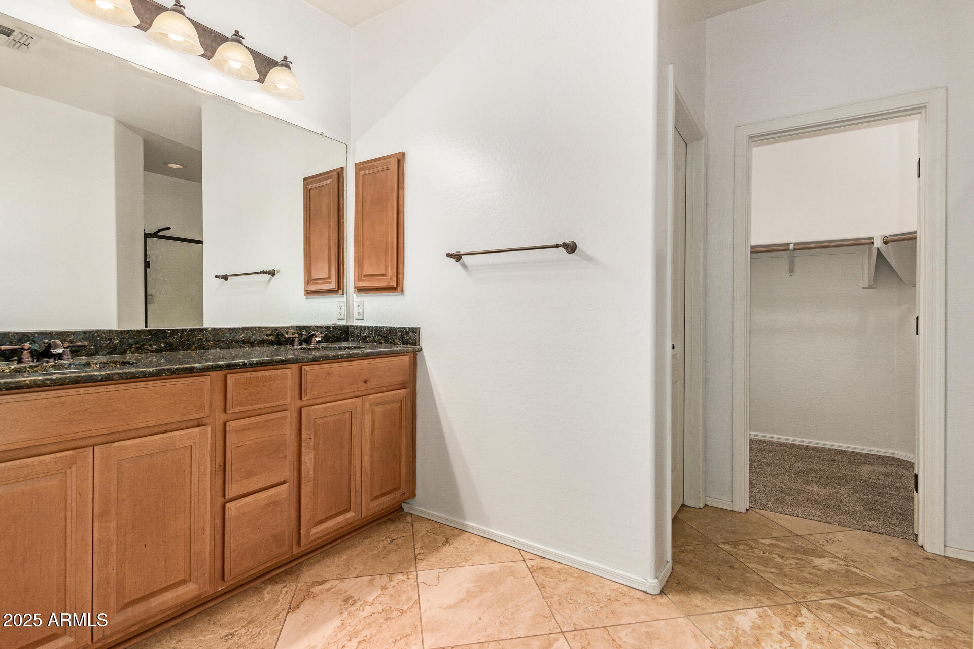 9228 West Black Hill Road Peoria, AZ 85383 - Photo 21 of 44 a bathroom with a granite countertop sink and a mirror