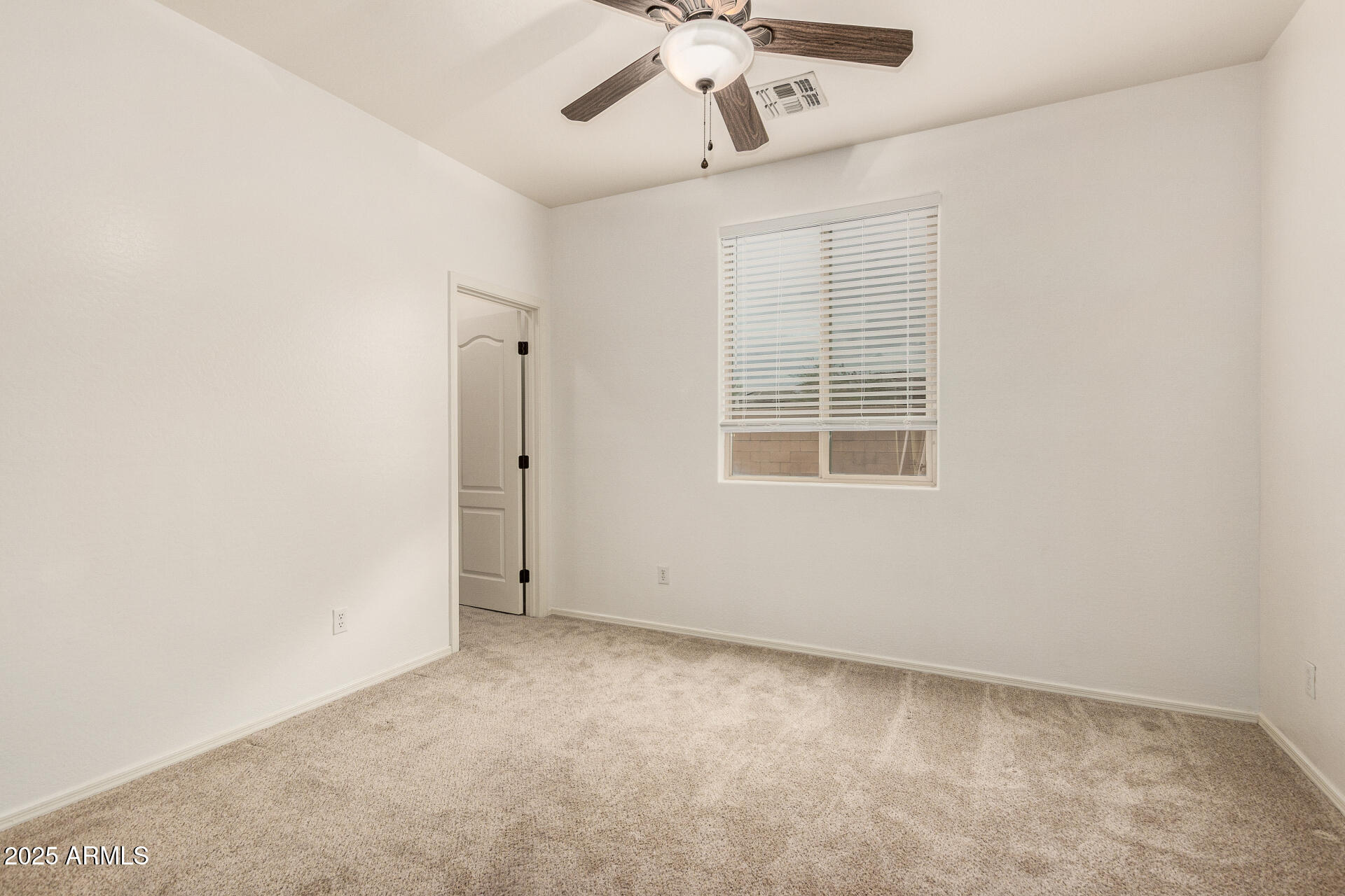 9228 West Black Hill Road Peoria, AZ 85383 - Photo 24 of 44 an empty room with a window