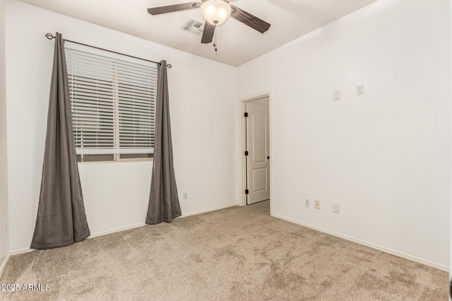 9228 West Black Hill Road Peoria, AZ 85383 - Photo 27 of 44 a view of a livingroom with a ceiling fan and window