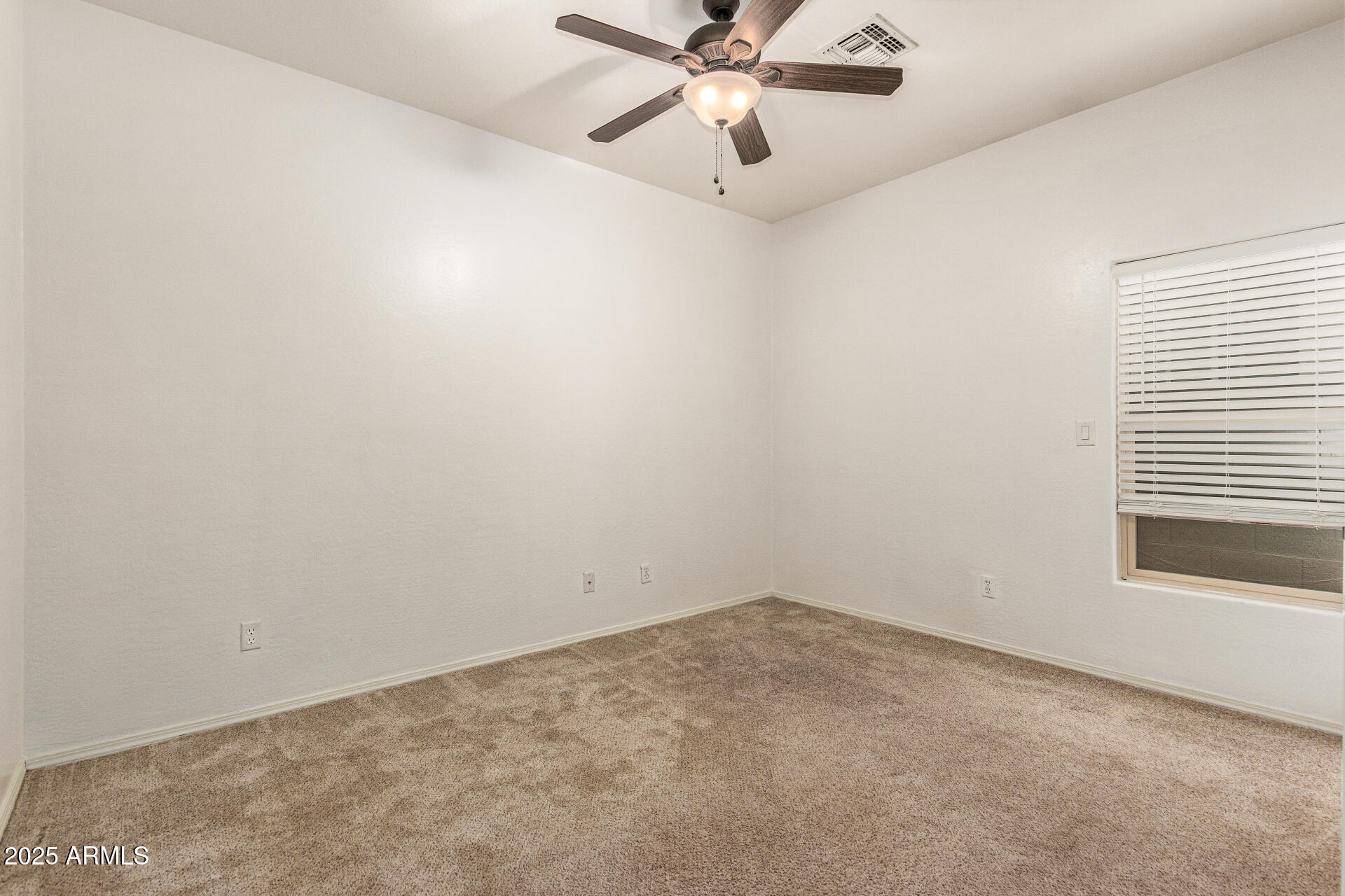 9228 West Black Hill Road Peoria, AZ 85383 - Photo 30 of 44 an empty room with a window and a fan
