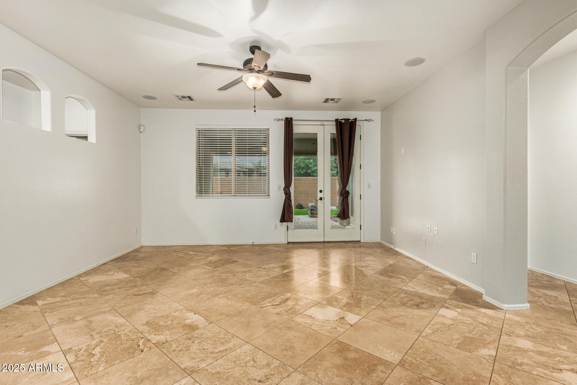 9228 West Black Hill Road Peoria, AZ 85383 - Photo 8 of 44 a view of an empty room with a window