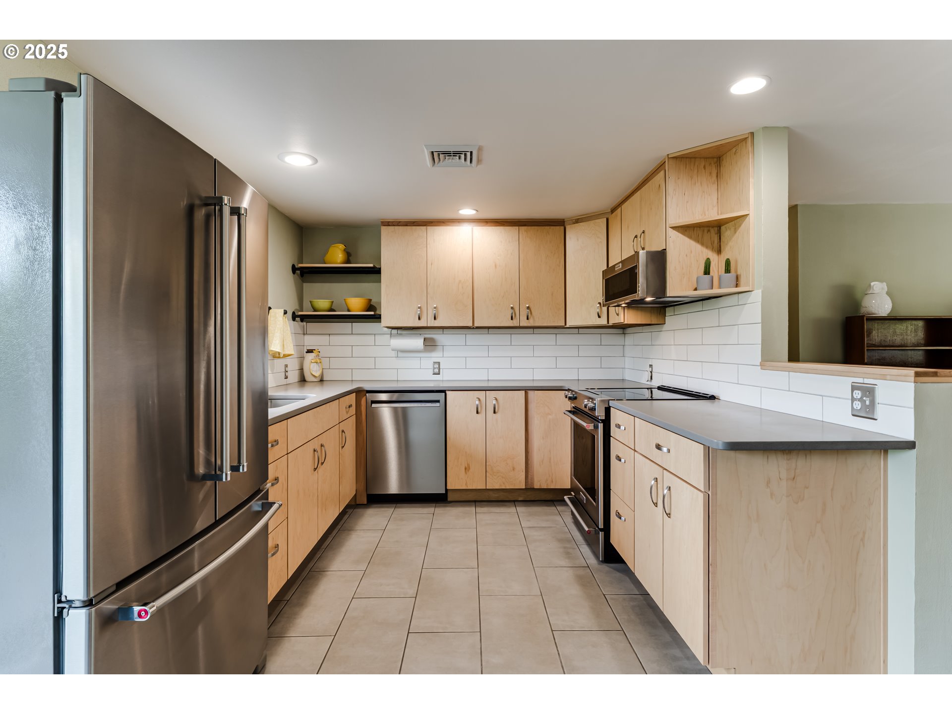 3140 Onyx Street Eugene, OR 97405 - Photo 11 of 32 a kitchen with stainless steel appliances granite countertop a stove a sink a refrigerator and cabinets