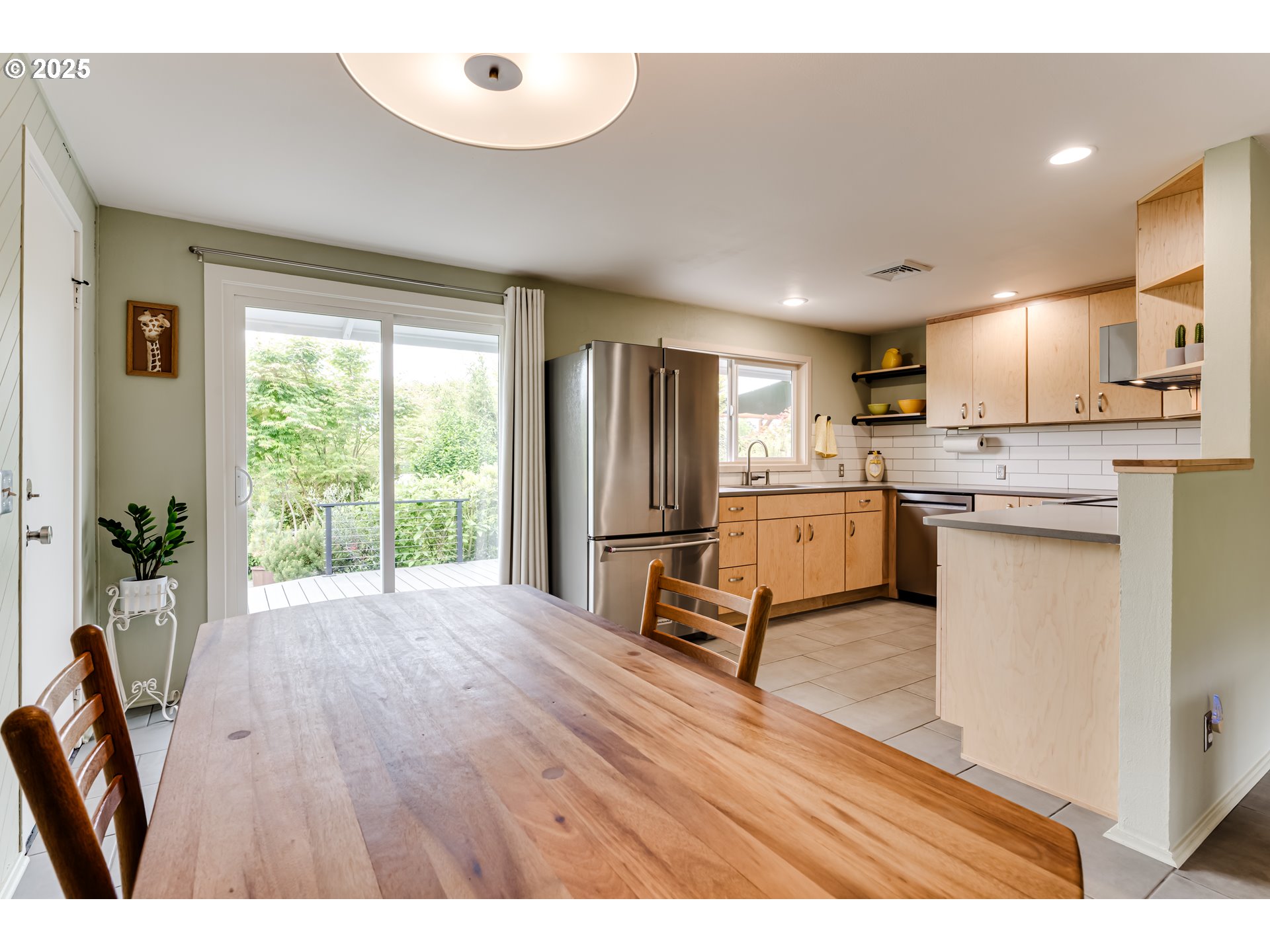 3140 Onyx Street Eugene, OR 97405 - Photo 12 of 32 a open kitchen with kitchen island wooden floors and stainless steel appliances