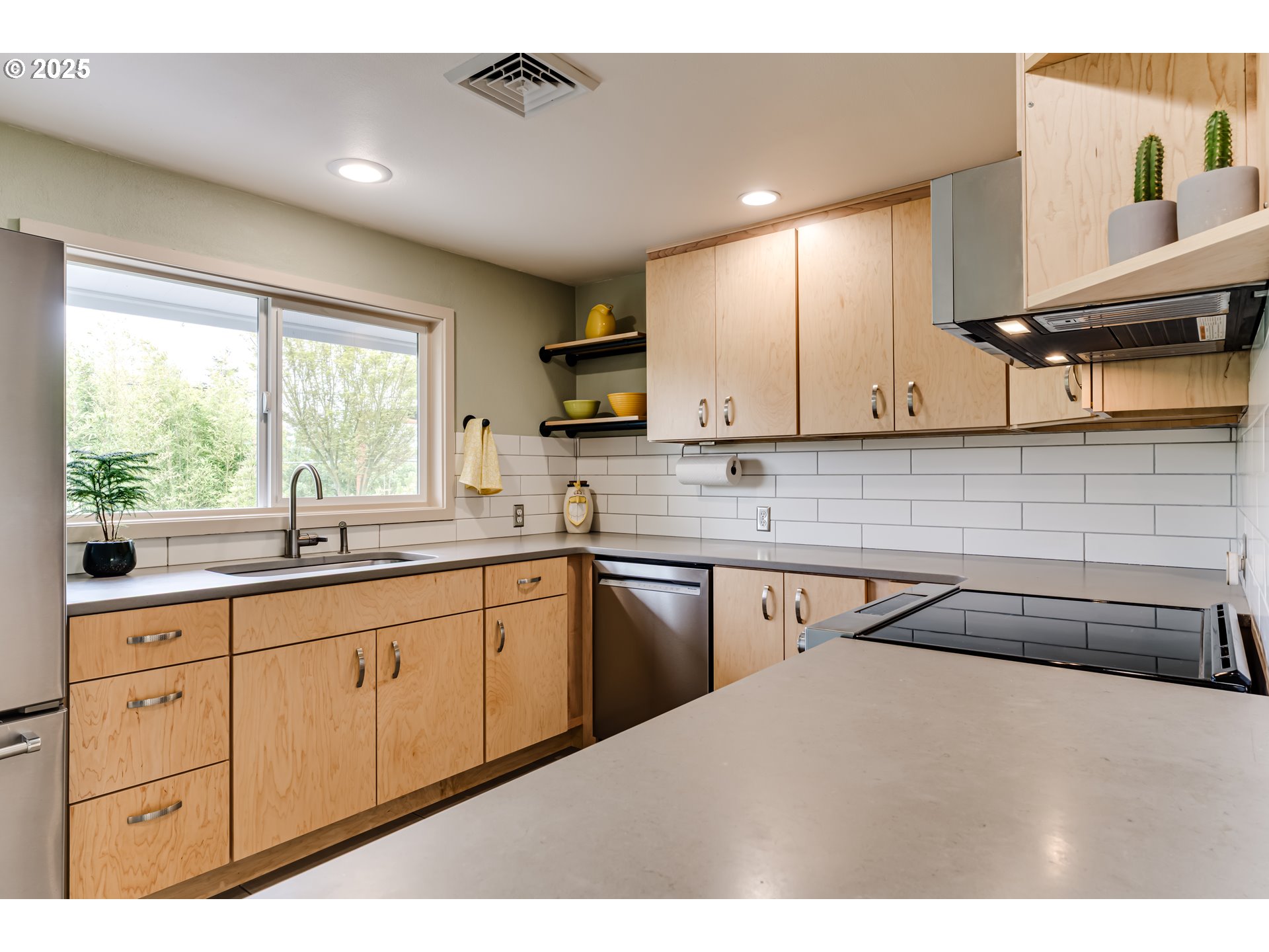 3140 Onyx Street Eugene, OR 97405 - Photo 13 of 32 a kitchen with granite countertop a sink window and cabinets