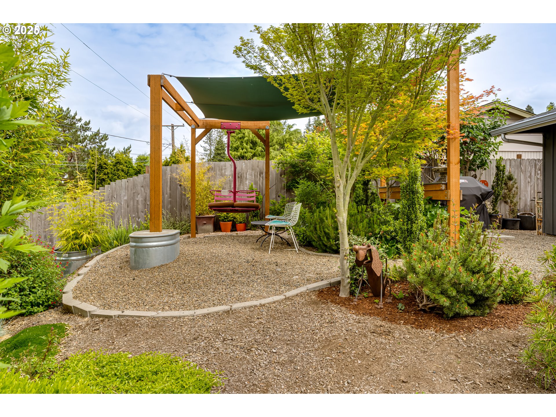 3140 Onyx Street Eugene, OR 97405 - Photo 22 of 32 a backyard of a house with table and chairs
