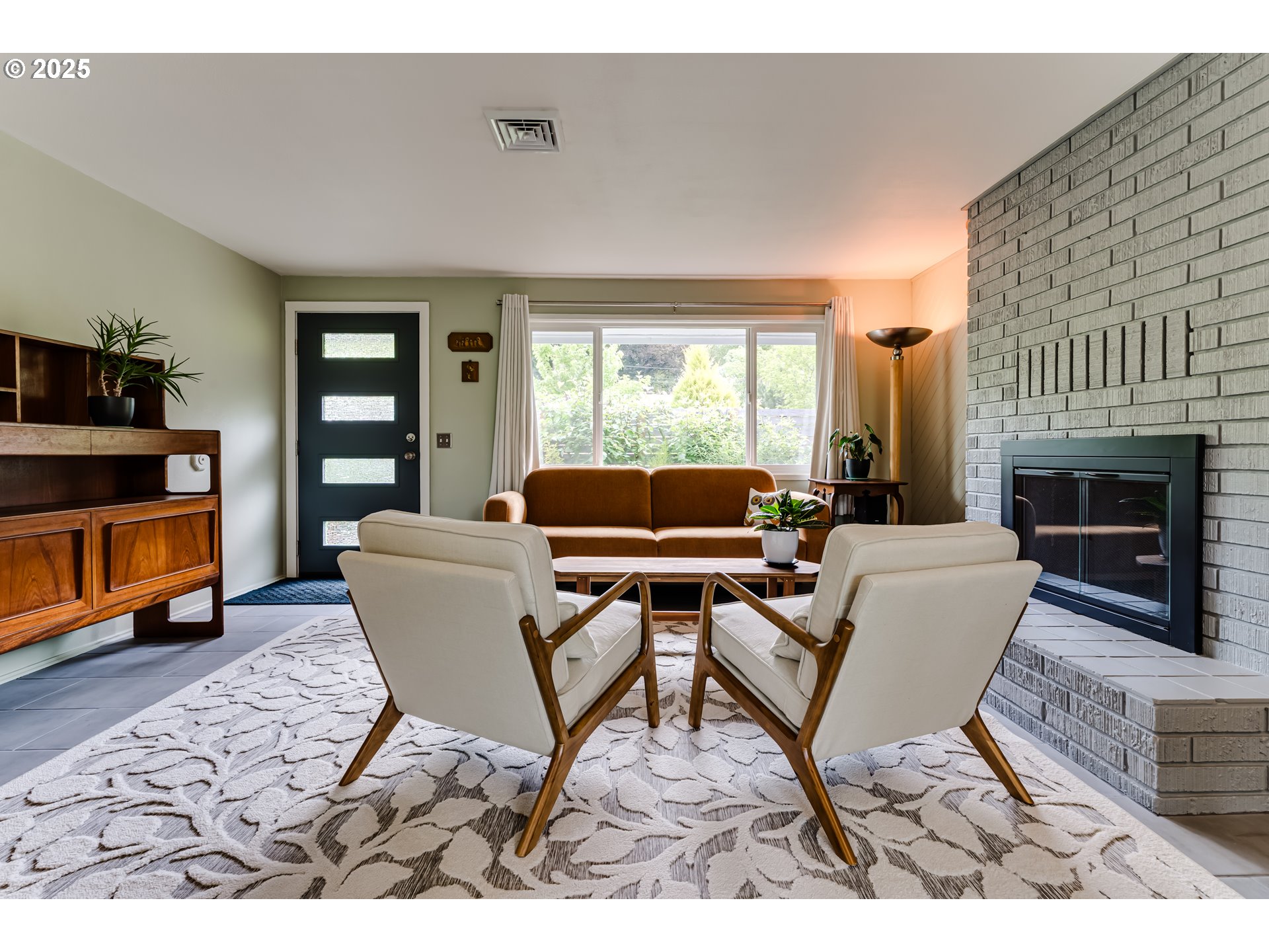 3140 Onyx Street Eugene, OR 97405 - Photo 7 of 32 a living room with furniture a fireplace and a flat screen tv