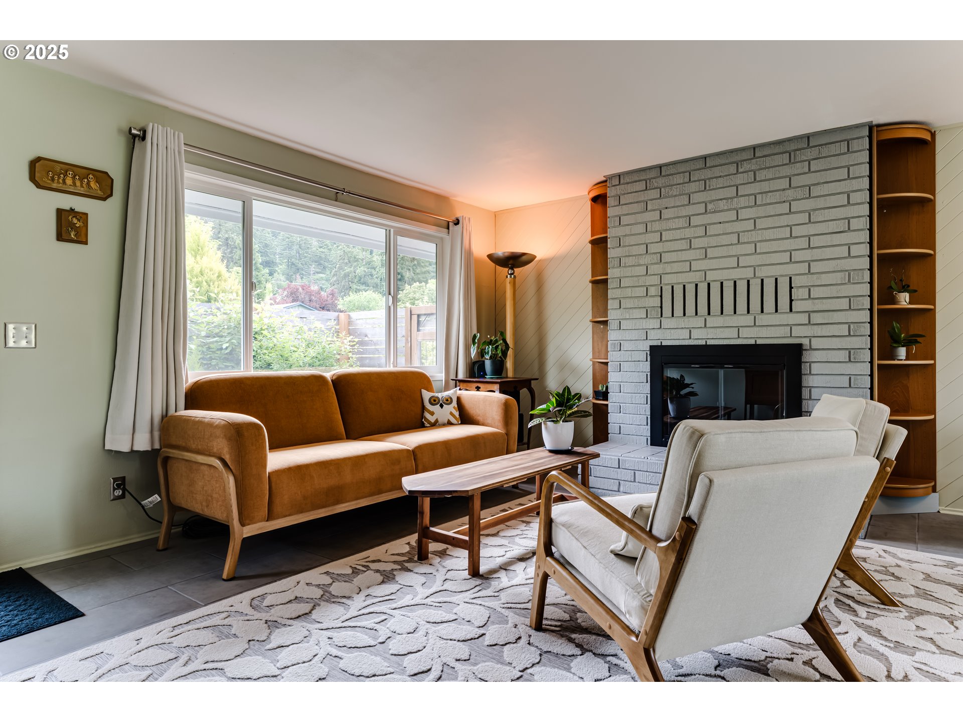 3140 Onyx Street Eugene, OR 97405 - Photo 9 of 32 a living room with furniture a fireplace and a table