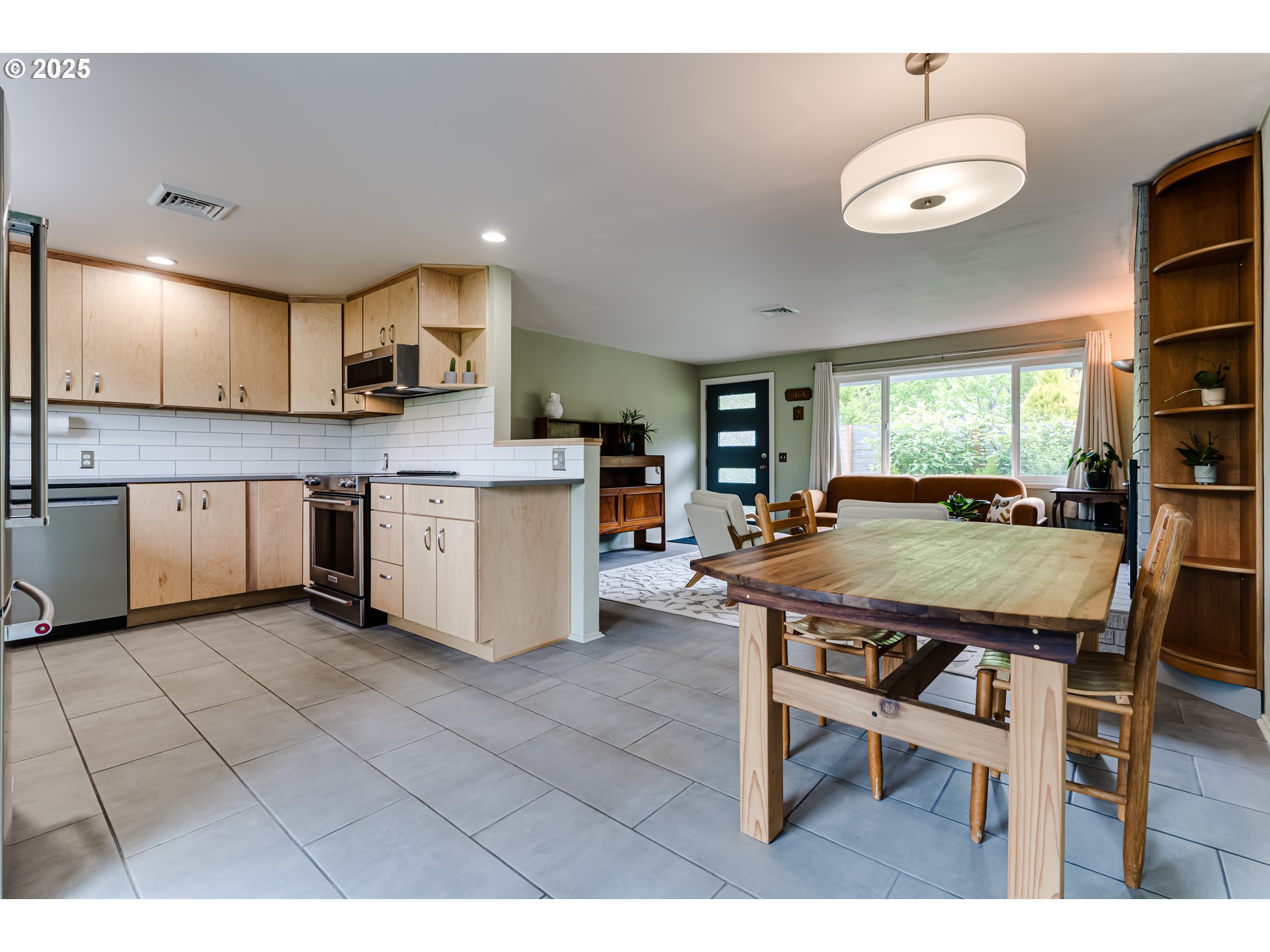 3140 Onyx Street Eugene, OR 97405 - Photo 10 of 32 a open kitchen with stainless steel appliances granite countertop a table chairs and a refrigerator
