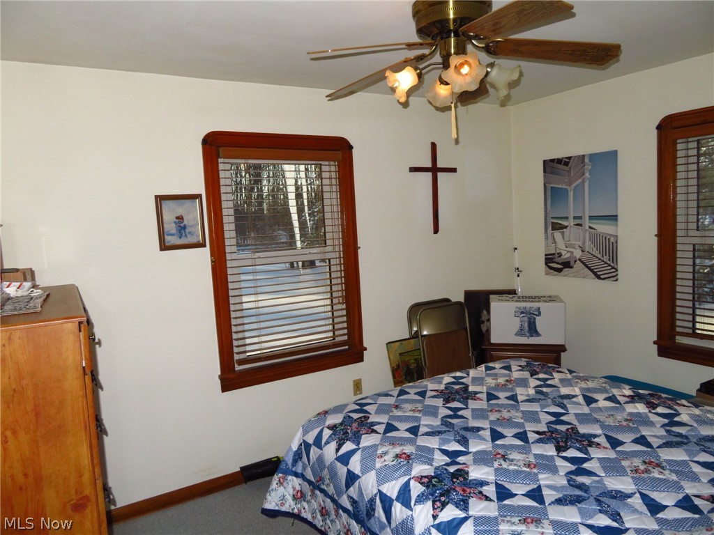 9499 Avon Belden Road North Ridgeville, OH 44039 - Photo 14 of 31 This is the larger of the 2 main floor bedrooms. Has a ceiling fan/light fixture, hardwood flooring under the carpeting, and vinyl replacement windows.