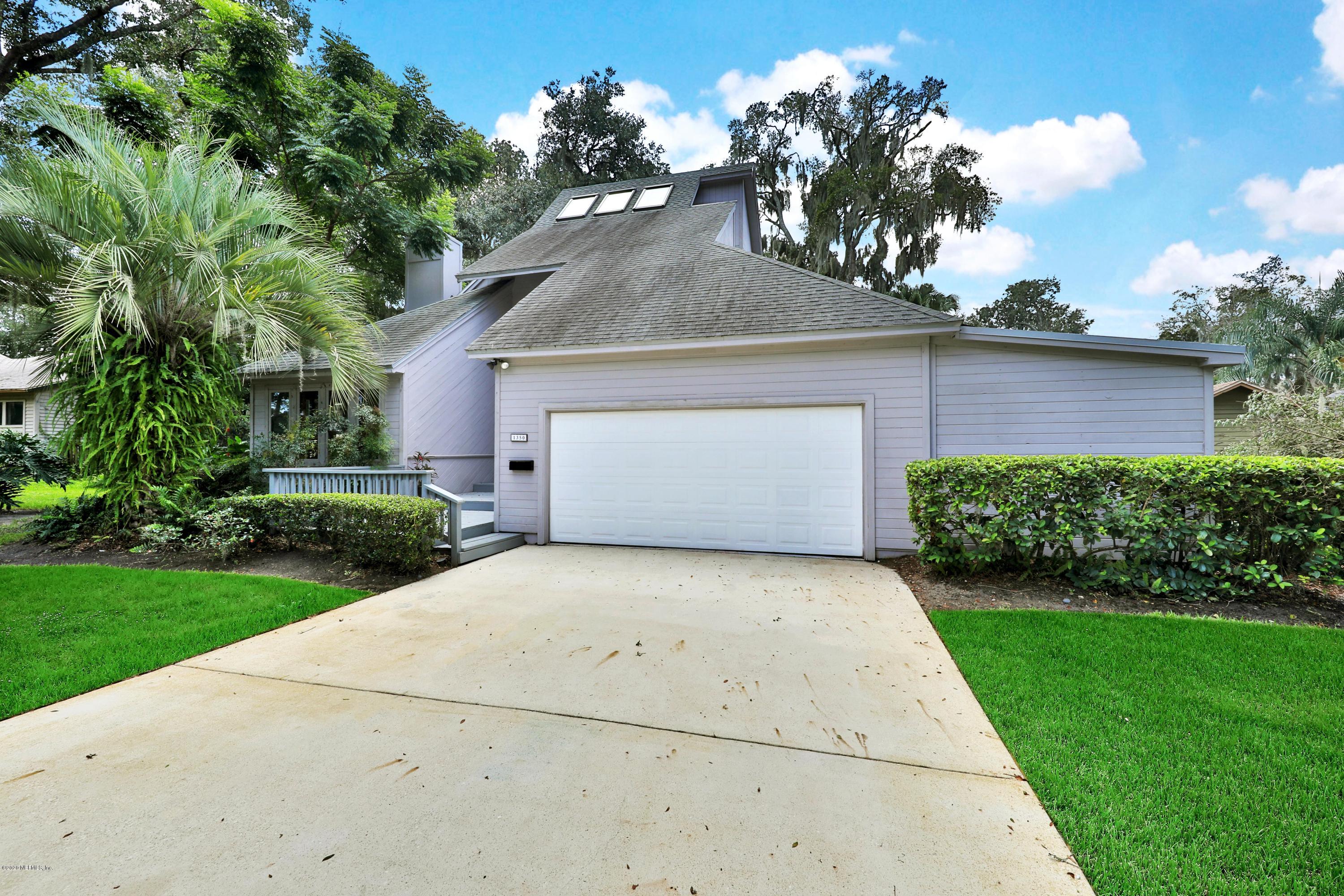 1350 Pinewood Road Jacksonville Beach, FL 32250 - Photo 12 of 45 a front view of a house with a yard and a garage